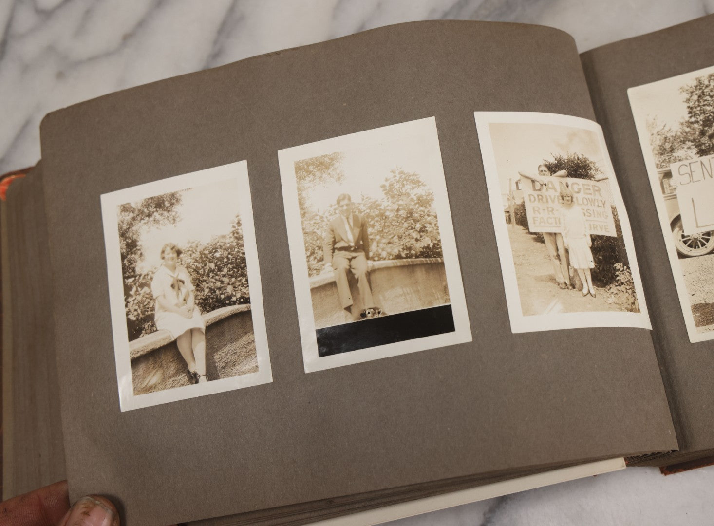 Lot 062 - Vintage Snapshot Photo Album With 125+ Photographs Including Photos Of Spirit Of St. Louis Plane, Redwood Forest, Automobiles, Outings, Comic Wedding Posters, Statue Of Liberty, Beachwear, And More