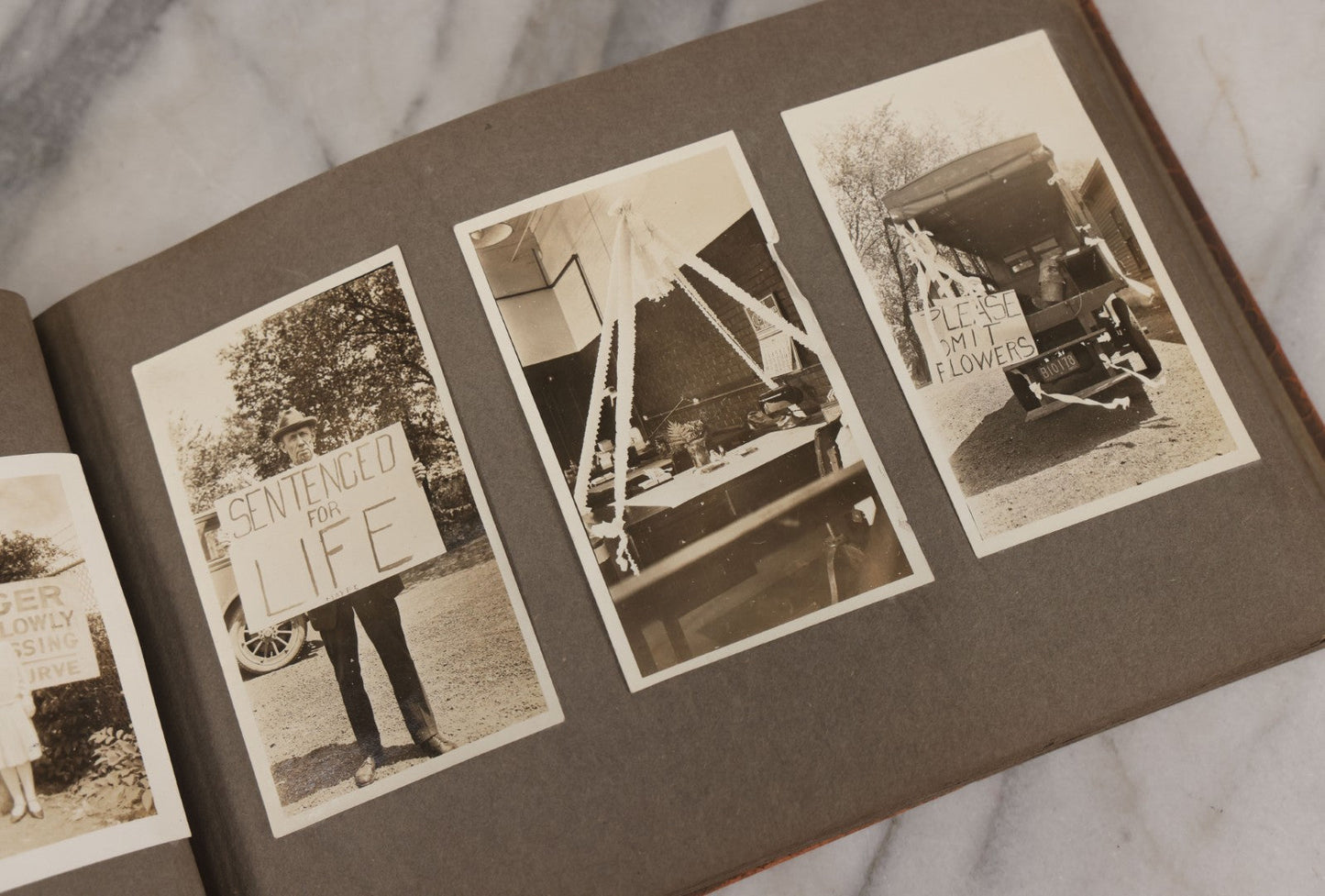 Lot 062 - Vintage Snapshot Photo Album With 125+ Photographs Including Photos Of Spirit Of St. Louis Plane, Redwood Forest, Automobiles, Outings, Comic Wedding Posters, Statue Of Liberty, Beachwear, And More