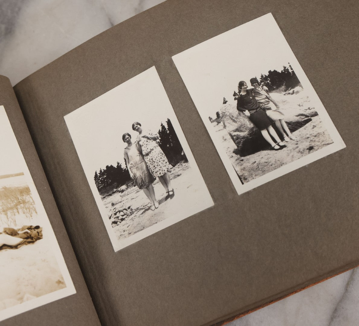 Lot 062 - Vintage Snapshot Photo Album With 125+ Photographs Including Photos Of Spirit Of St. Louis Plane, Redwood Forest, Automobiles, Outings, Comic Wedding Posters, Statue Of Liberty, Beachwear, And More