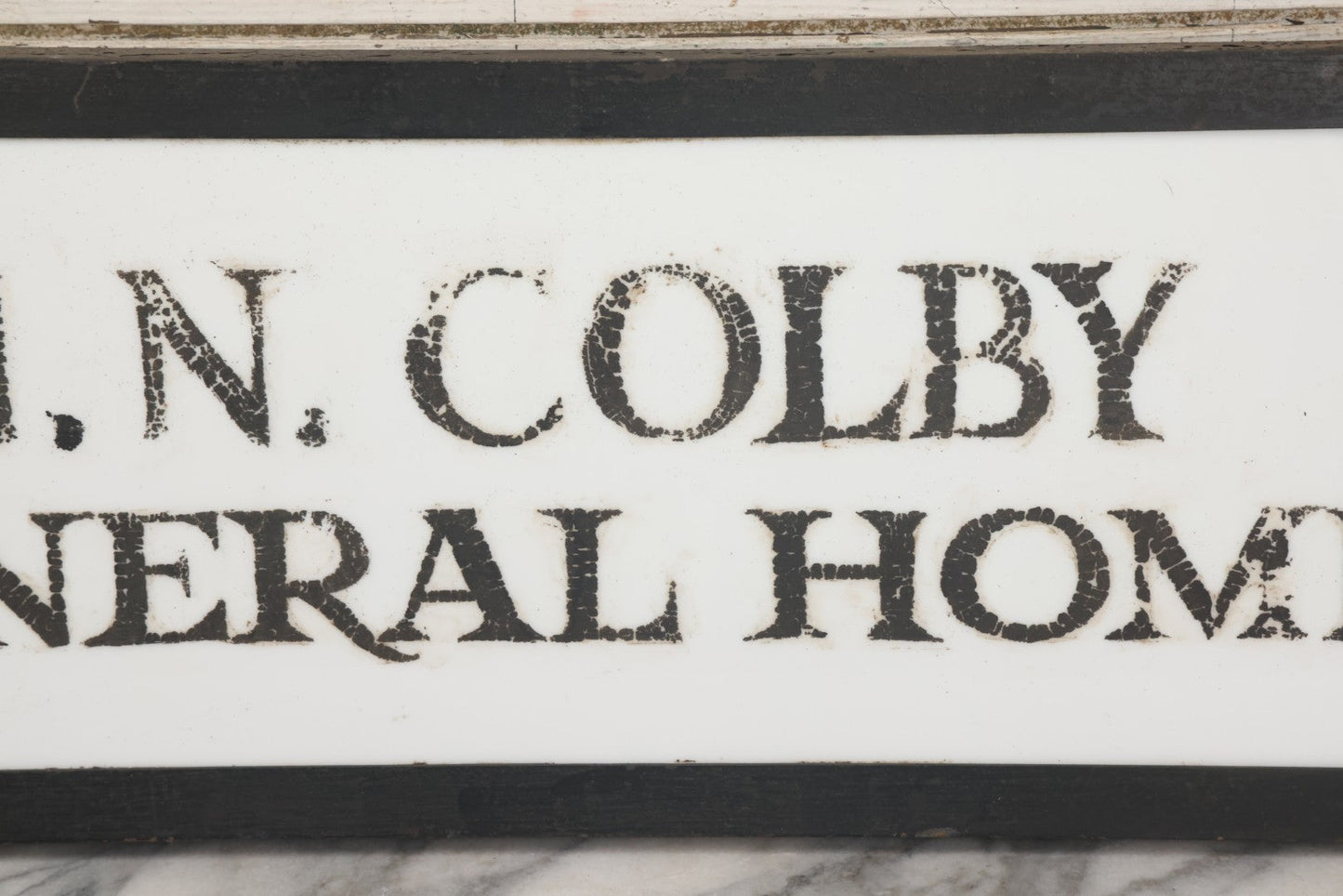 Lot 001 - Vintage Hand Painted Sign For "H.N. Colby Funeral Home" Lawrence, Massachusetts, In Metal Frame With Brackets, Painted On Vitrolite "Better Than Marble Composite Material," Circa 1940s, 25-5/8" L x 8-1/2" H