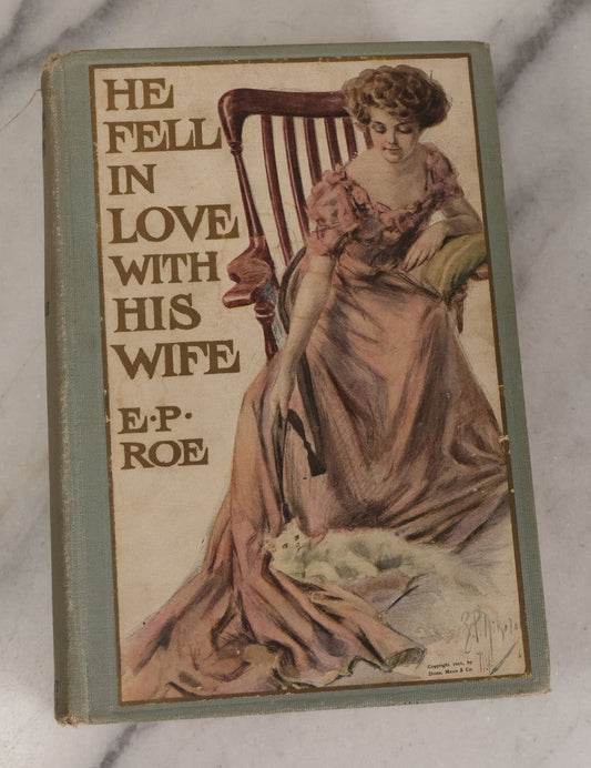 Lot 110 - "He Fell In Love With His Wife" Antique Romance Novel By Edward P. Roe, With Cover Art Of Woman Playing With Fluffy White Cat, Illustrated By Z.P. Nikolaki, Grosset & Dunlap, Publishers, New York, Copyright 1911, By Dodd, Mead & Co.