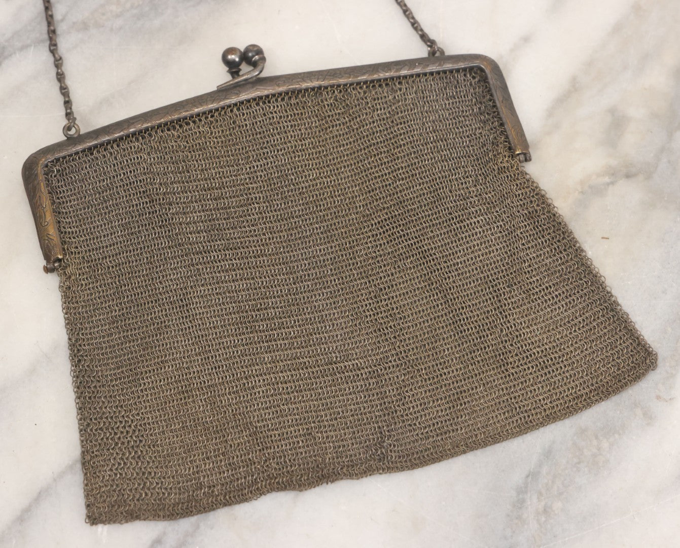 Lot 010 - Antique Whiting & Davis Co. German Silver Soldered Mesh Purse With Chain Handle And Engraved Lily Flower Decoration