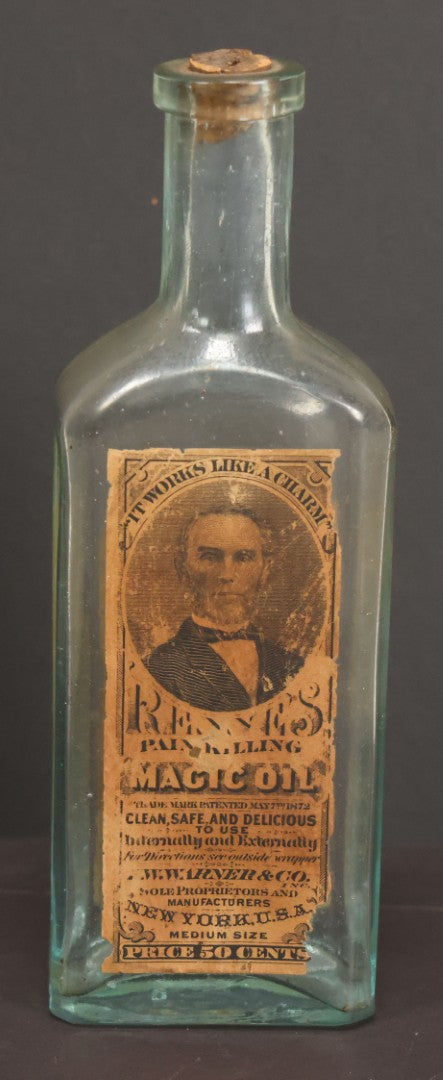 Lot 013 - Antique Bottle With Embossed Text And Original Paper Labels For Renne's Pain Killing Magic Oil Patent Medicine, "It Works Like A Charm; Clean Safe And Delicious" Manufactured By T.W. Warner & Co., New York, 6" Height