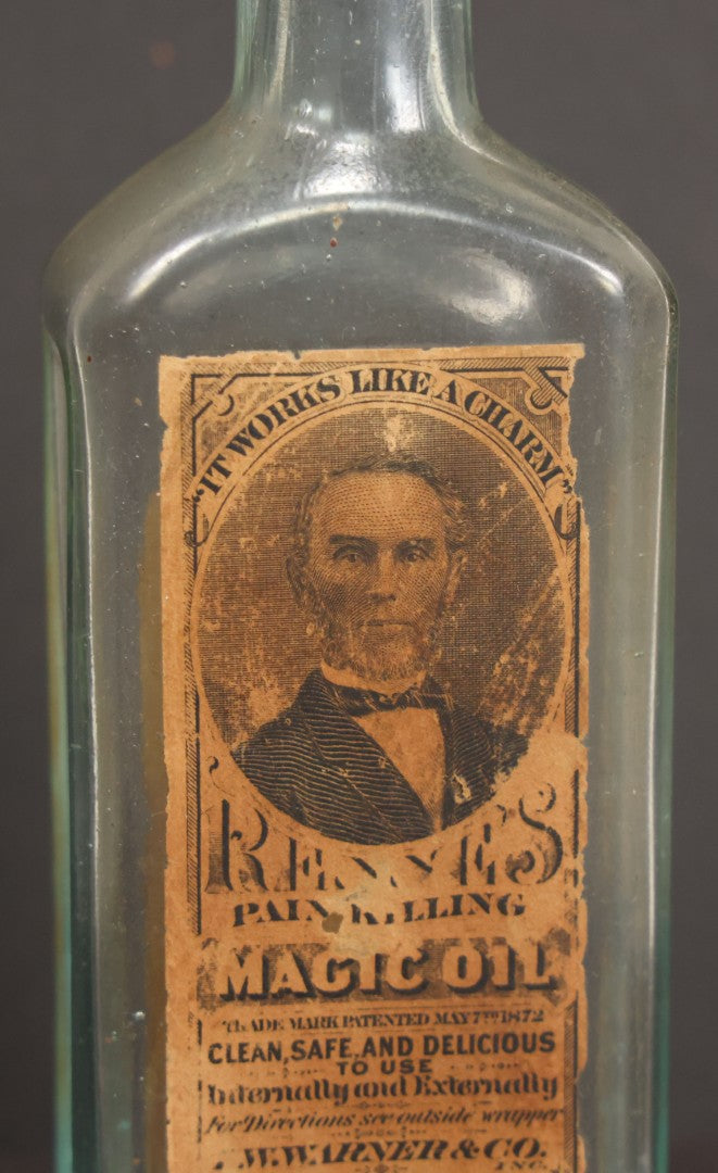 Lot 013 - Antique Bottle With Embossed Text And Original Paper Labels For Renne's Pain Killing Magic Oil Patent Medicine, "It Works Like A Charm; Clean Safe And Delicious" Manufactured By T.W. Warner & Co., New York, 6" Height
