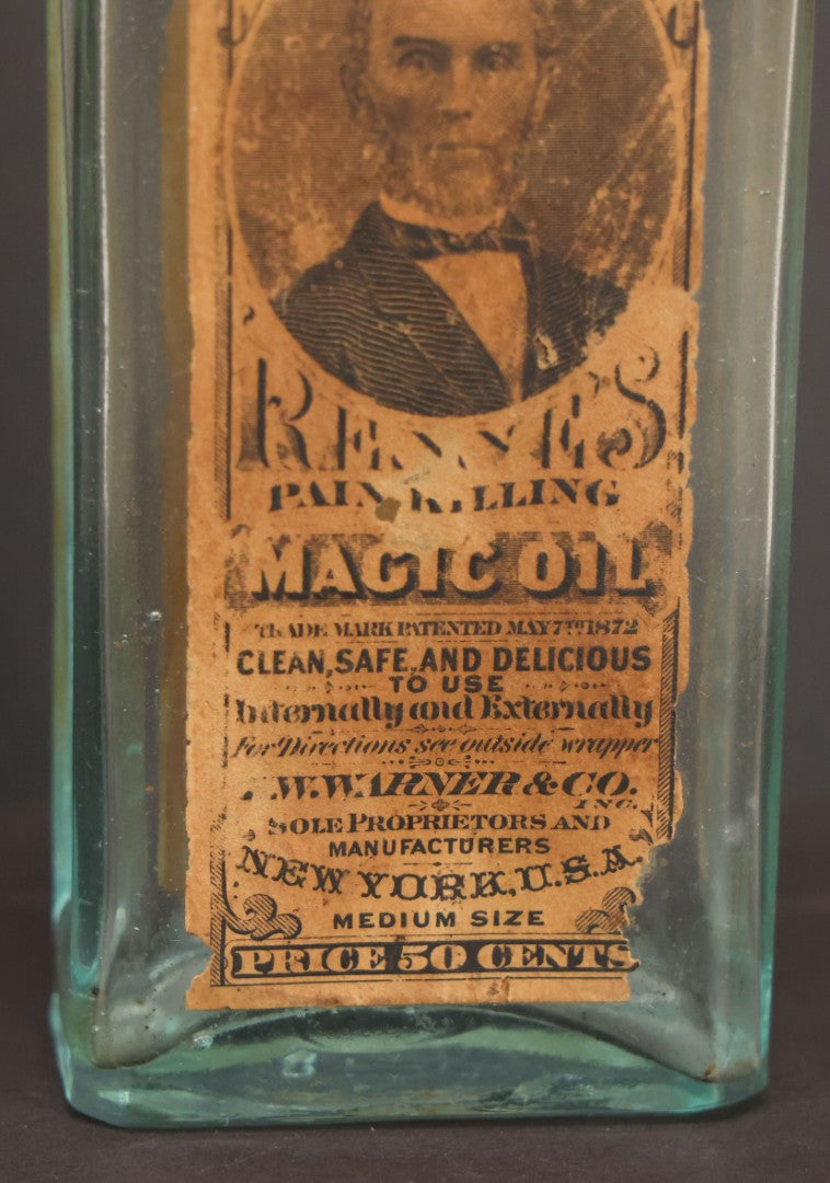 Lot 013 - Antique Bottle With Embossed Text And Original Paper Labels For Renne's Pain Killing Magic Oil Patent Medicine, "It Works Like A Charm; Clean Safe And Delicious" Manufactured By T.W. Warner & Co., New York, 6" Height