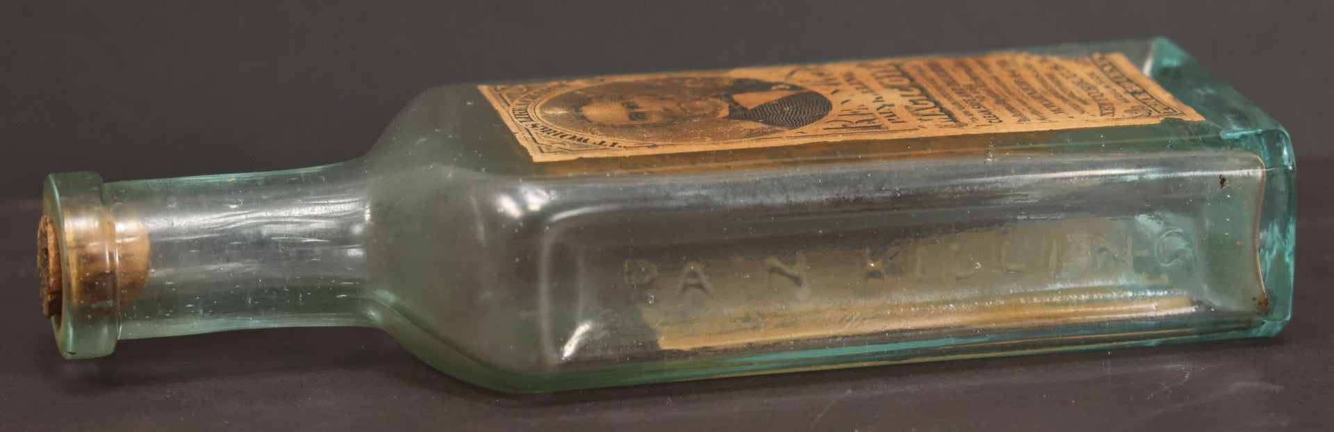 Lot 013 - Antique Bottle With Embossed Text And Original Paper Labels For Renne's Pain Killing Magic Oil Patent Medicine, "It Works Like A Charm; Clean Safe And Delicious" Manufactured By T.W. Warner & Co., New York, 6" Height