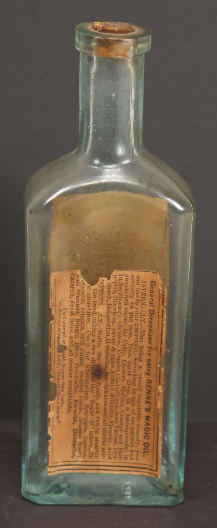 Lot 013 - Antique Bottle With Embossed Text And Original Paper Labels For Renne's Pain Killing Magic Oil Patent Medicine, "It Works Like A Charm; Clean Safe And Delicious" Manufactured By T.W. Warner & Co., New York, 6" Height