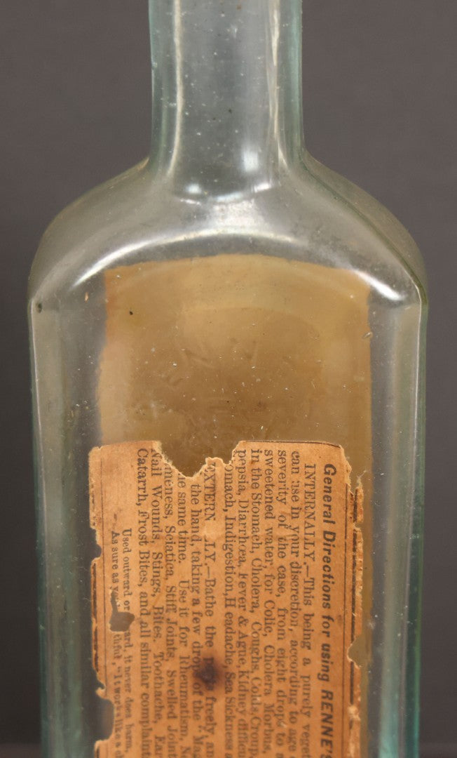 Lot 013 - Antique Bottle With Embossed Text And Original Paper Labels For Renne's Pain Killing Magic Oil Patent Medicine, "It Works Like A Charm; Clean Safe And Delicious" Manufactured By T.W. Warner & Co., New York, 6" Height