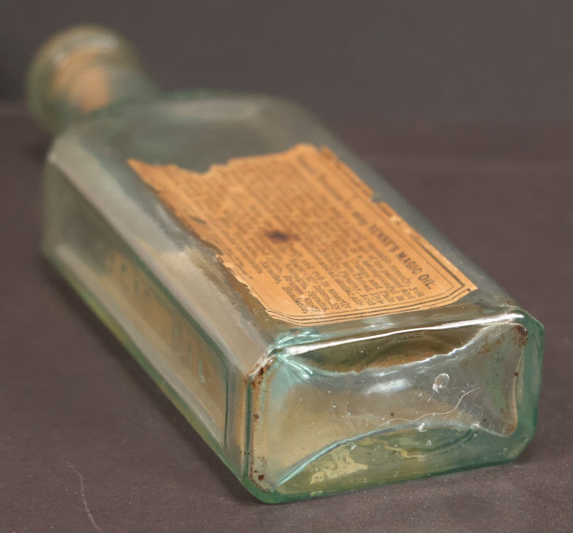 Lot 013 - Antique Bottle With Embossed Text And Original Paper Labels For Renne's Pain Killing Magic Oil Patent Medicine, "It Works Like A Charm; Clean Safe And Delicious" Manufactured By T.W. Warner & Co., New York, 6" Height
