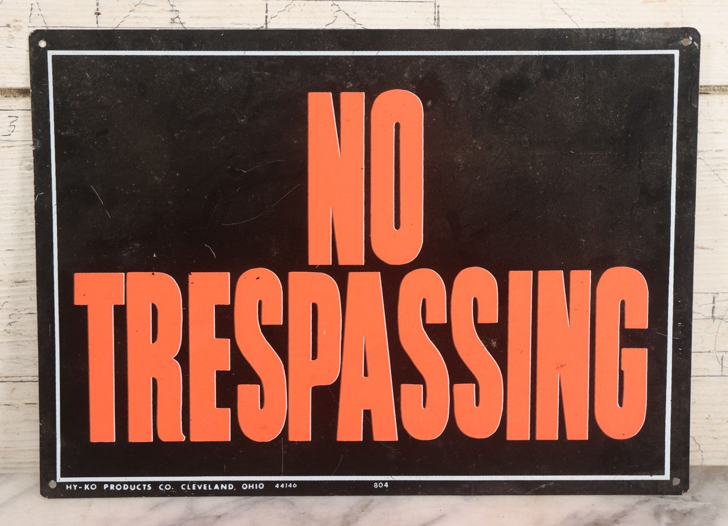 Lot 019 - Vintage Printed Tin Tacker Metal "No Trespassing" Black Sign, Manufactured By H.Y.-K.O. Products Co., Cleveland, Ohio, 14" W x 10" H