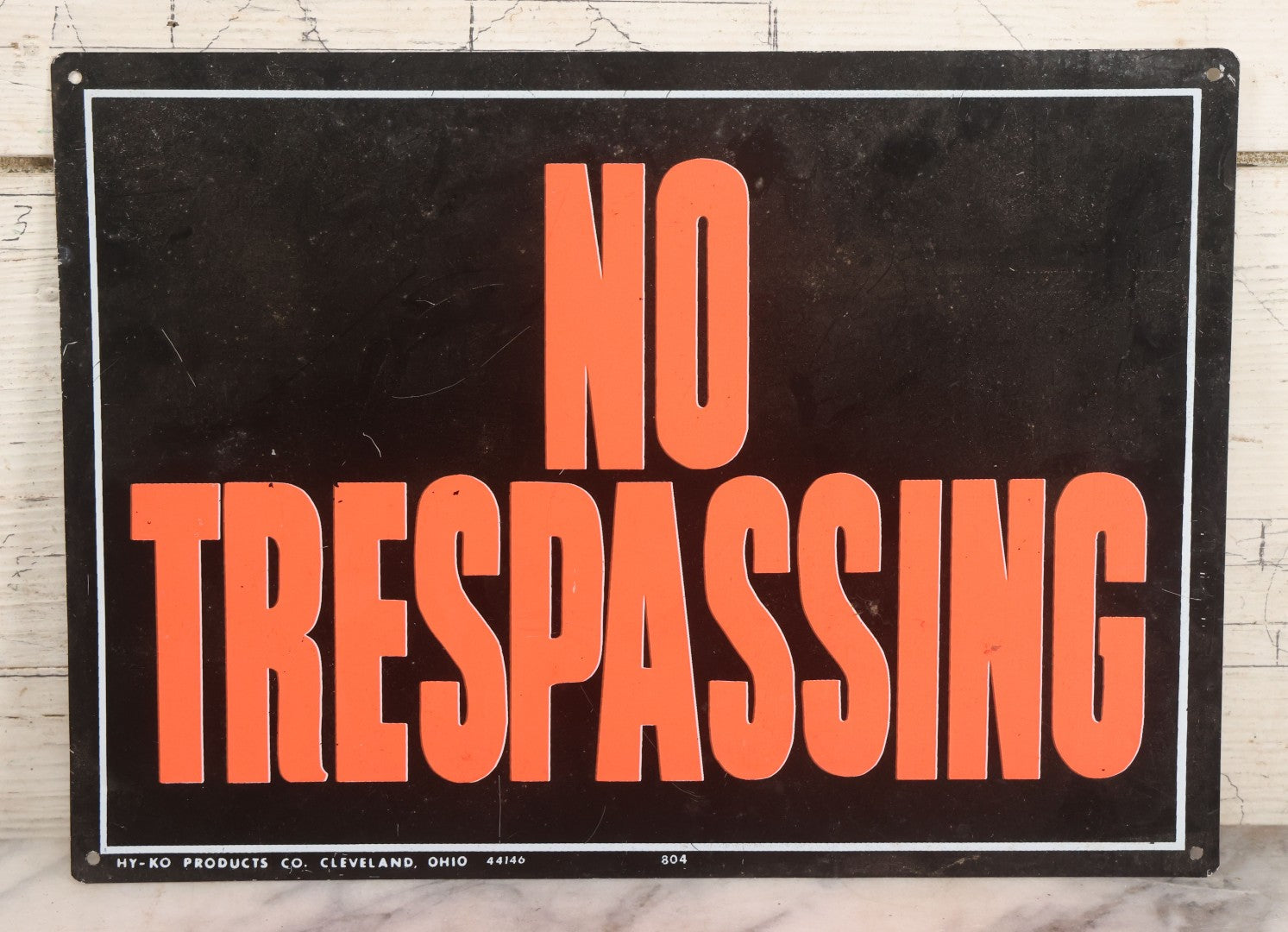 Lot 019 - Vintage Printed Tin Tacker Metal "No Trespassing" Black Sign, Manufactured By H.Y.-K.O. Products Co., Cleveland, Ohio, 14" W x 10" H