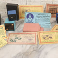 Lot 037 - Vintage Magician's Grouping With Several Foldered Card Tricks, Nesting Dice Tricks, String Of Cards Trick, Dummy Card Deck, And Other Misc. Pieces