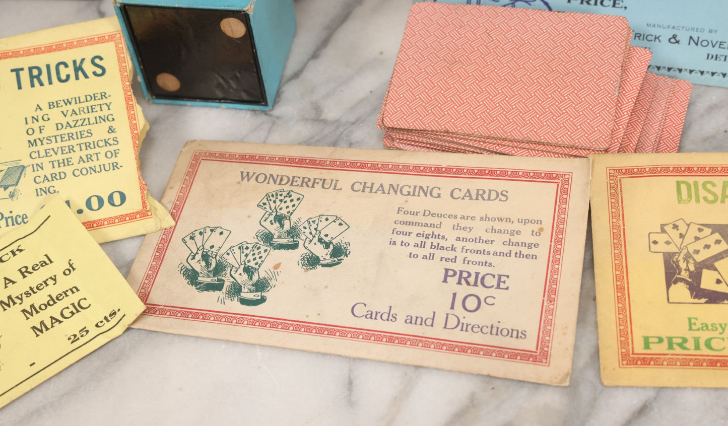 Lot 037 - Vintage Magician's Grouping With Several Foldered Card Tricks, Nesting Dice Tricks, String Of Cards Trick, Dummy Card Deck, And Other Misc. Pieces