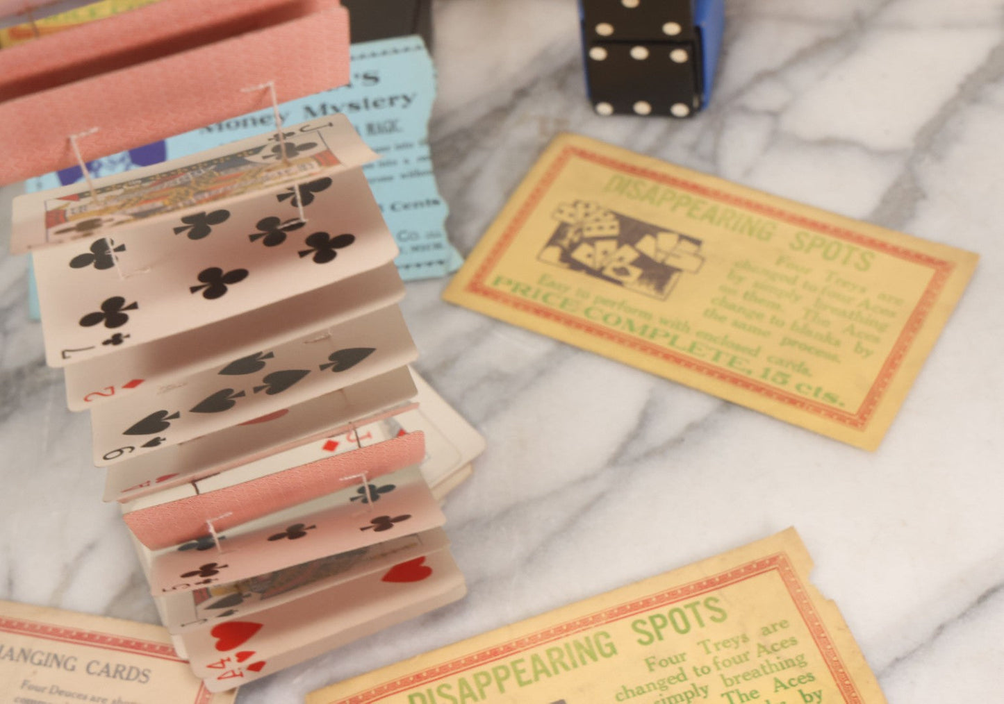 Lot 037 - Vintage Magician's Grouping With Several Foldered Card Tricks, Nesting Dice Tricks, String Of Cards Trick, Dummy Card Deck, And Other Misc. Pieces