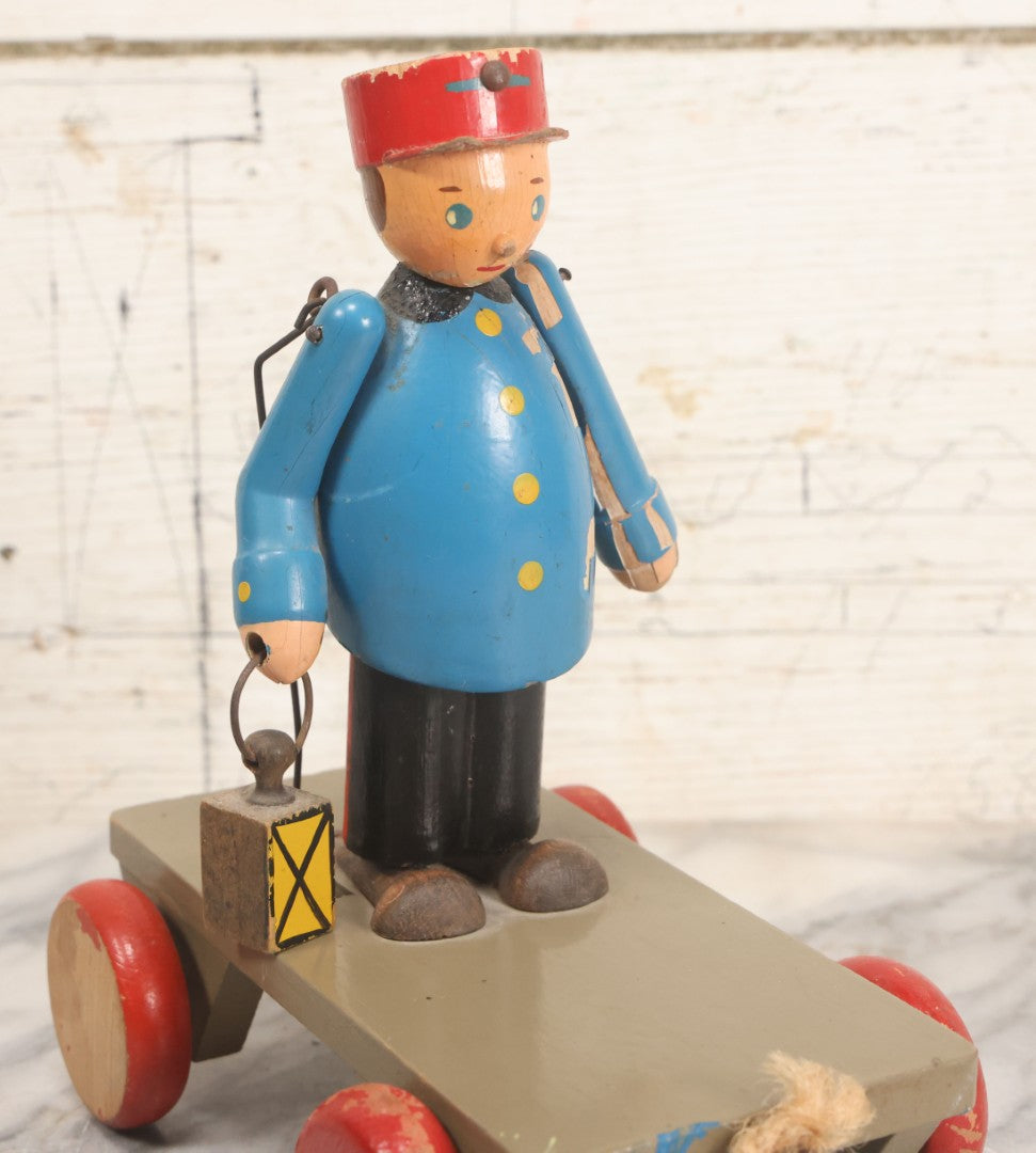 Lot 044 - Vintage Handmade Wooden Wheeled Cart With Train Conductor Holding Lantern Animated Pull Toy, Lantern Arm Moves Up And Down, Made In Czechoslovakia, Note Paint Losses