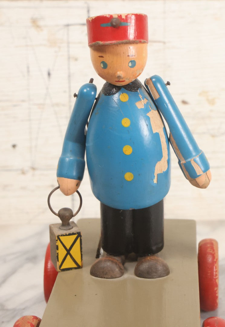 Lot 044 - Vintage Handmade Wooden Wheeled Cart With Train Conductor Holding Lantern Animated Pull Toy, Lantern Arm Moves Up And Down, Made In Czechoslovakia, Note Paint Losses
