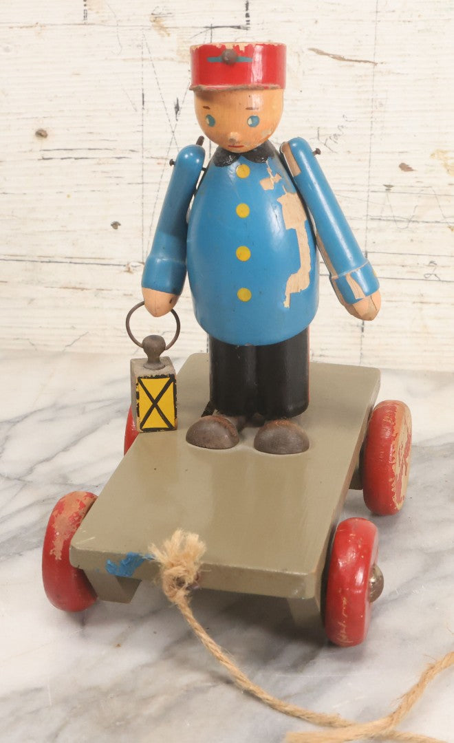 Lot 044 - Vintage Handmade Wooden Wheeled Cart With Train Conductor Holding Lantern Animated Pull Toy, Lantern Arm Moves Up And Down, Made In Czechoslovakia, Note Paint Losses