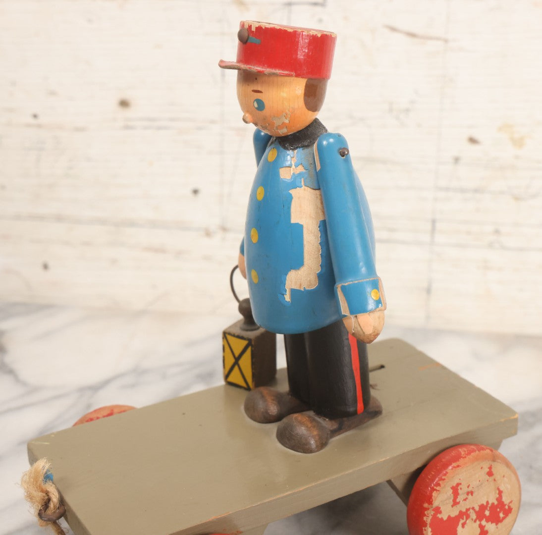 Lot 044 - Vintage Handmade Wooden Wheeled Cart With Train Conductor Holding Lantern Animated Pull Toy, Lantern Arm Moves Up And Down, Made In Czechoslovakia, Note Paint Losses