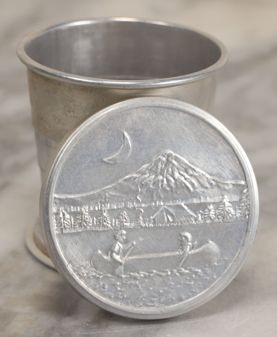 Lot 048 - Vintage Collapsible Camping Tin Cup With Embossed Lid With Children Canoeing In Front Of Mountain At Night