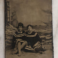 Lot 074 - Single Antique Tintype Photograph Of Two Victorian Ladies In Beachwear Posing On Real Sand Set With Painted Backdrop With Lighthouse And Ships