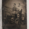 Lot 075 - Single Antique Tintype Photograph Of Two Ladies Posing In An Early Automobile In Studio With Landscape Backdrop