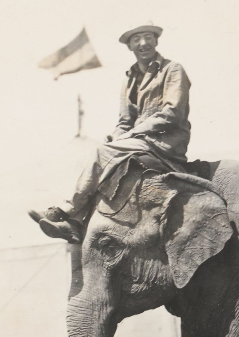 Lot 080 - Vintage Snapshot Photo Album Page With A Photo Of Circus Worker Seated Atop An Elephant's Head, Other Photos On Verso