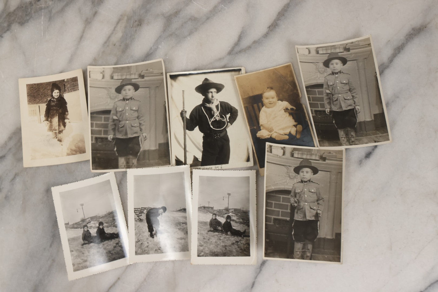 Lot 085 - Grouping Of 50+ Vintage Snapshot Photographs, Mostly Of Children At Play, Including Boy Dressed As Cowboy, Boy Dressed As Canadian Mountie Police Officer With Pistol, Children Skiing, Sledding, And More, Circa 1920s To 1960s