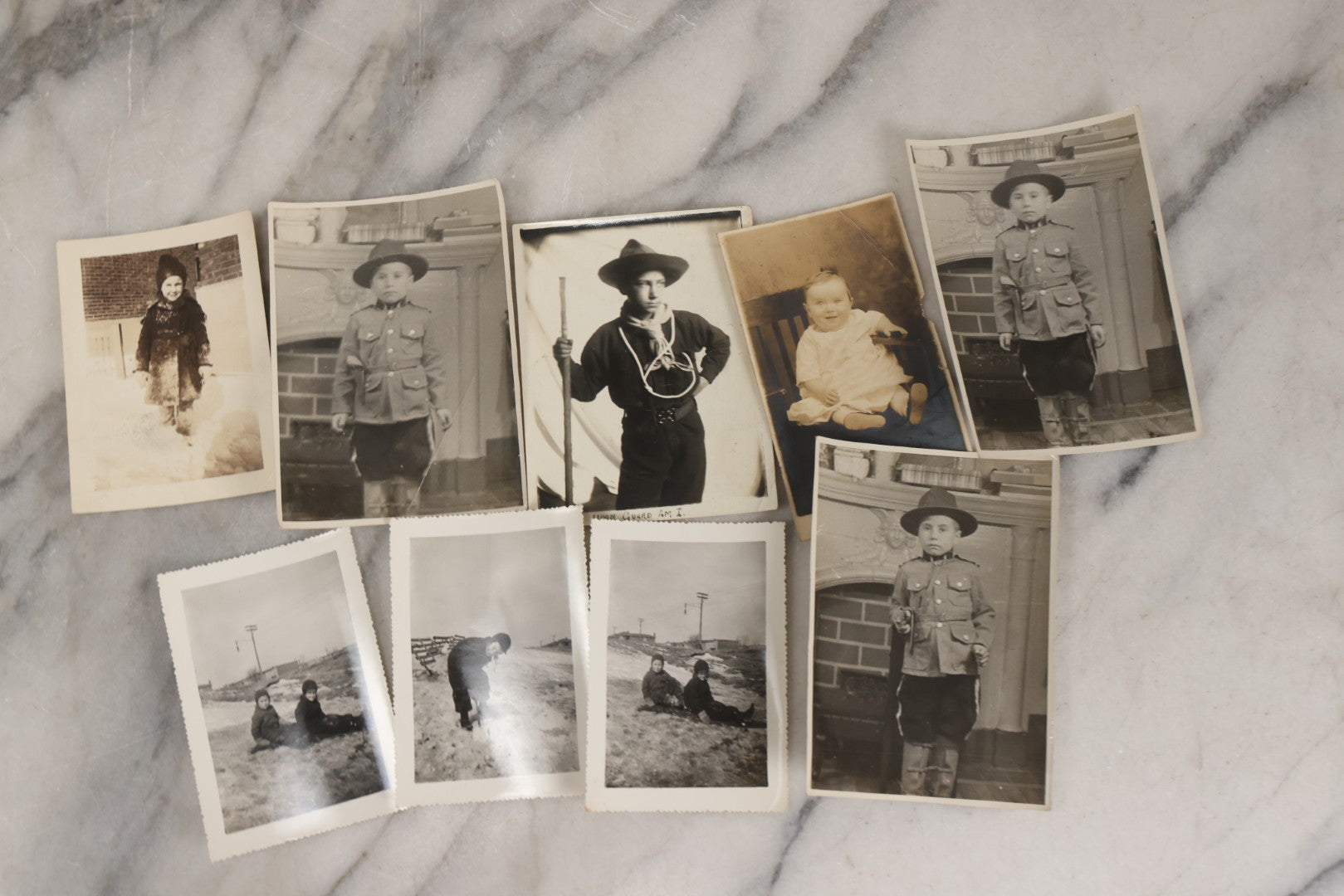 Lot 085 - Grouping Of 50+ Vintage Snapshot Photographs, Mostly Of Children At Play, Including Boy Dressed As Cowboy, Boy Dressed As Canadian Mountie Police Officer With Pistol, Children Skiing, Sledding, And More, Circa 1920s To 1960s