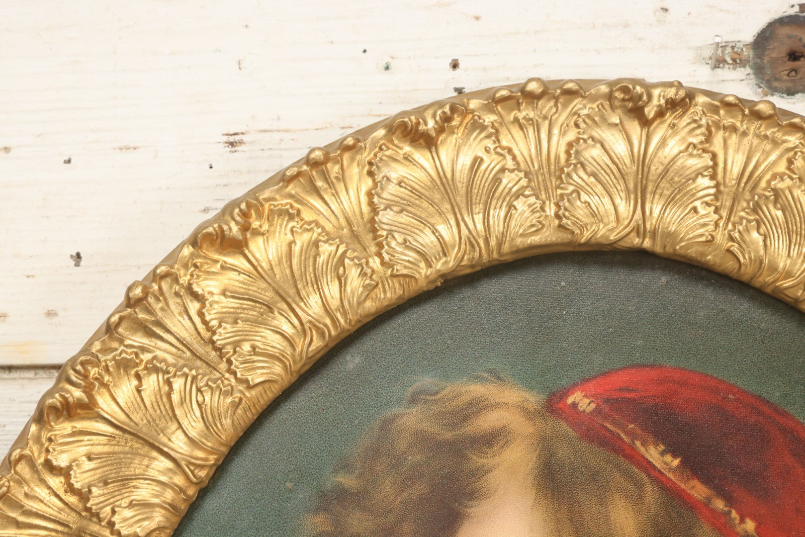 Lot 006 - Antique Chromolithograph Portrait Print Of Blue-Eyed Brunette Beauty With Red Velvet Cap And Loose Fitting Red Gown In Ornate Gilded Molded Gesso Oval Frame, 21" x 25"