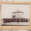 Lot 140 - Antique Boarded Photograph Of Group Of Women In Dark Attire Posing Outside Two Story Home, Including Men In Top Hats And Woman In Wheelchair, Photographed By U.H. Henry, Prescott, Washington