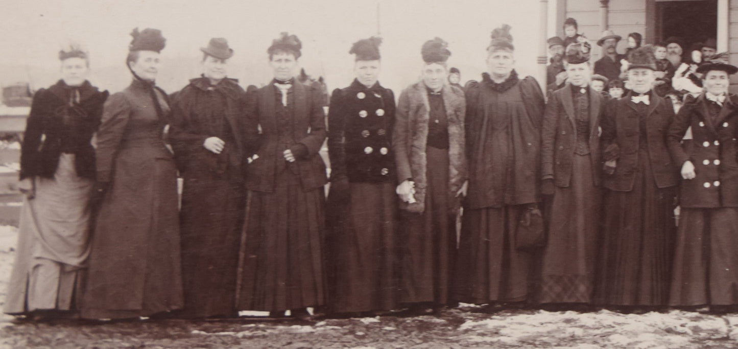 Lot 140 - Antique Boarded Photograph Of Group Of Women In Dark Attire Posing Outside Two Story Home, Including Men In Top Hats And Woman In Wheelchair, Photographed By U.H. Henry, Prescott, Washington