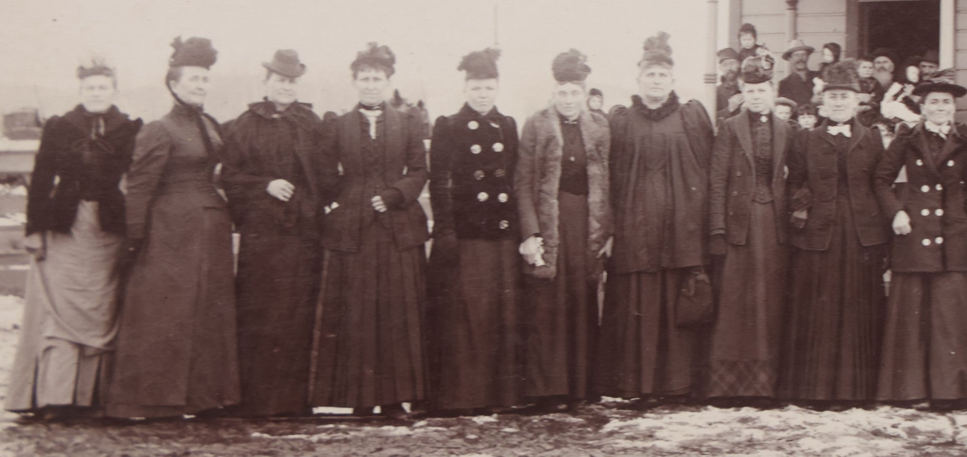 Lot 140 - Antique Boarded Photograph Of Group Of Women In Dark Attire Posing Outside Two Story Home, Including Men In Top Hats And Woman In Wheelchair, Photographed By U.H. Henry, Prescott, Washington