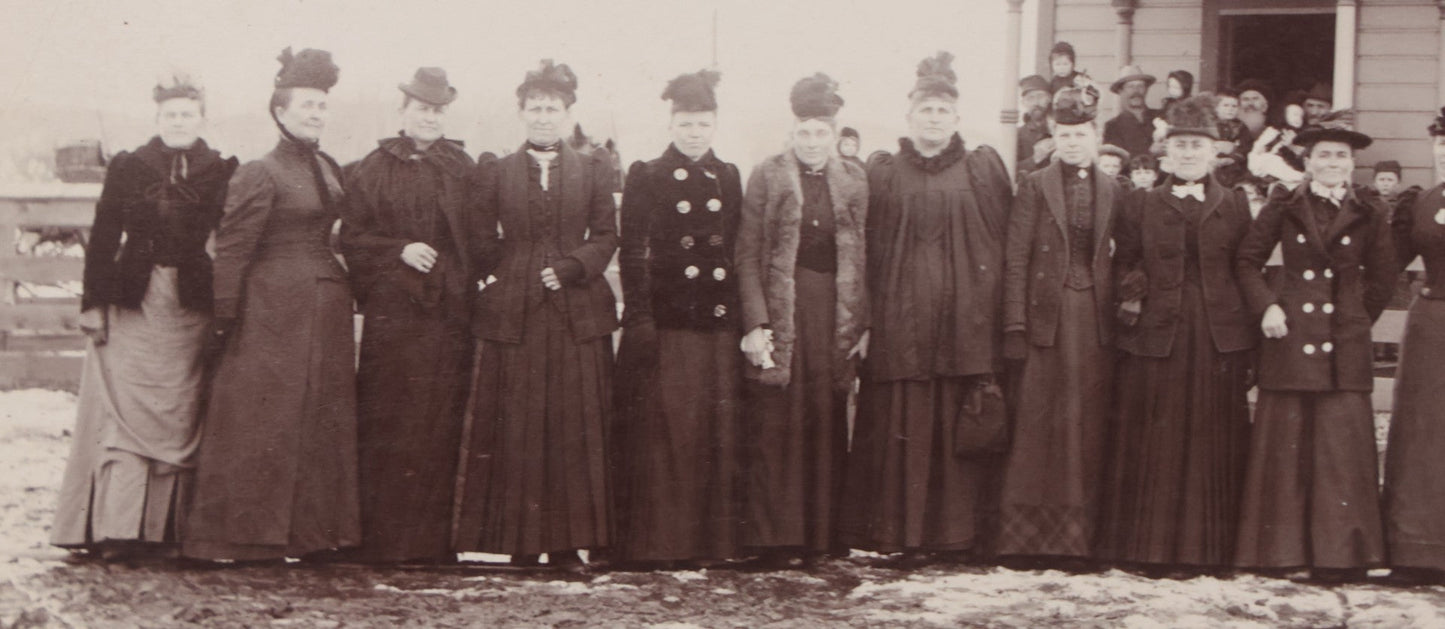 Lot 140 - Antique Boarded Photograph Of Group Of Women In Dark Attire Posing Outside Two Story Home, Including Men In Top Hats And Woman In Wheelchair, Photographed By U.H. Henry, Prescott, Washington