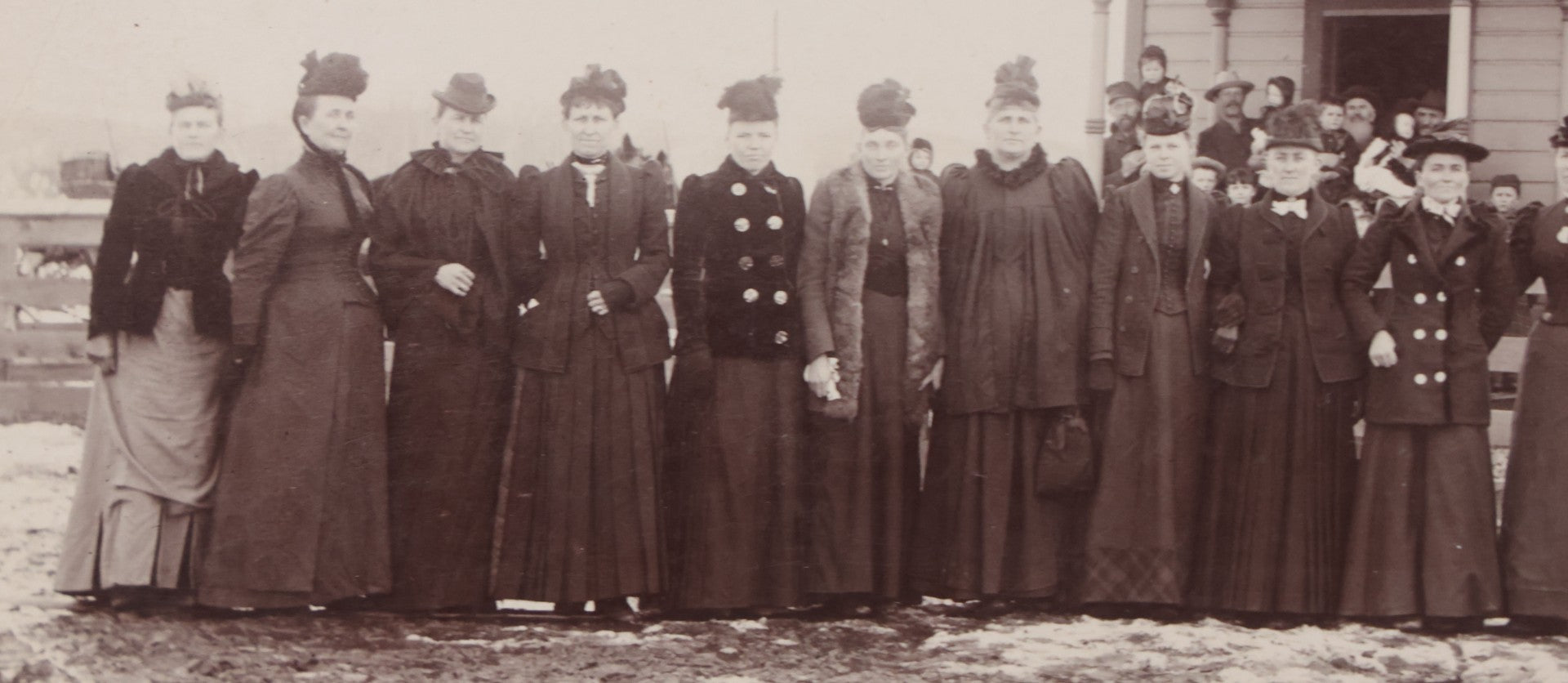 Lot 140 - Antique Boarded Photograph Of Group Of Women In Dark Attire Posing Outside Two Story Home, Including Men In Top Hats And Woman In Wheelchair, Photographed By U.H. Henry, Prescott, Washington