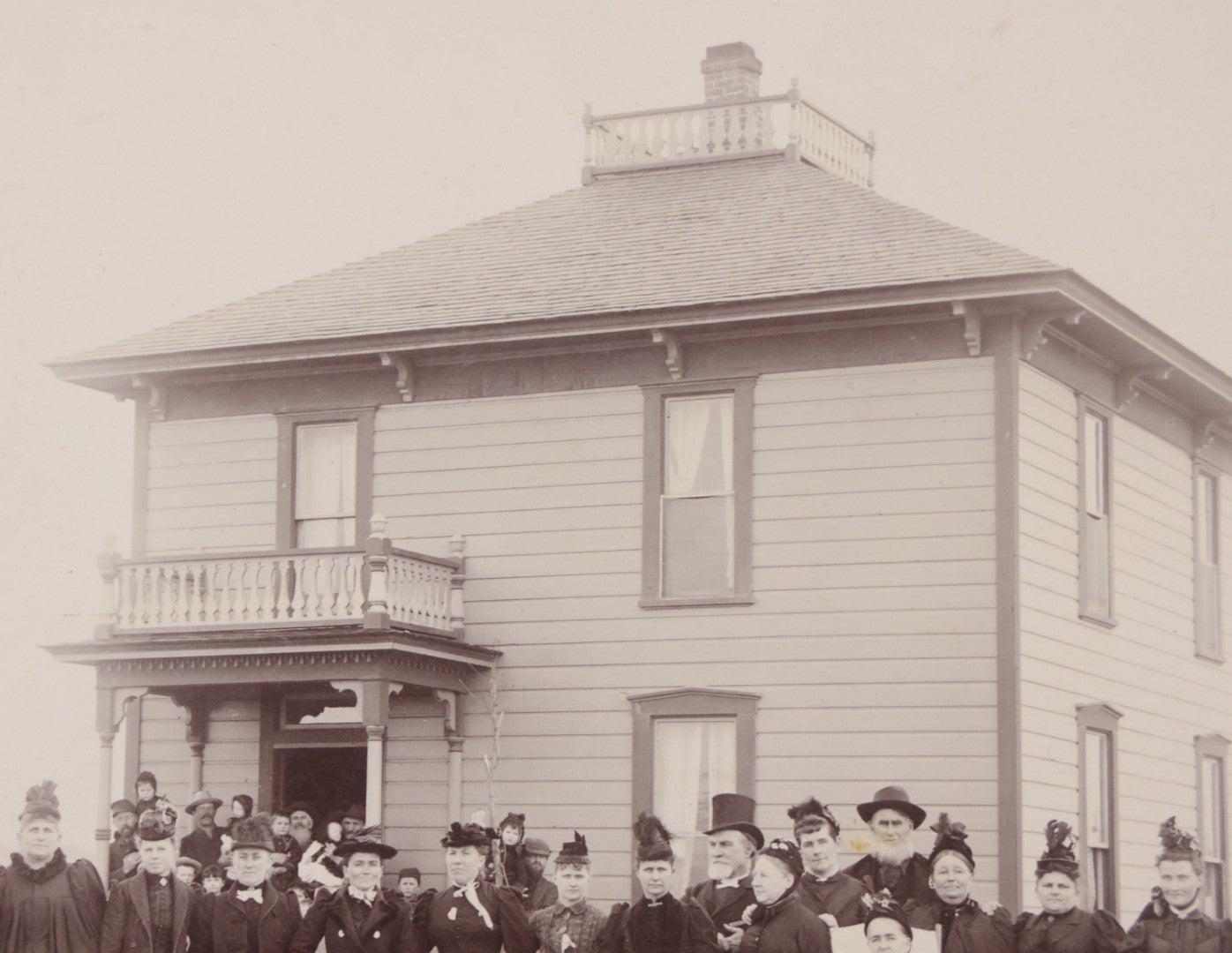 Lot 140 - Antique Boarded Photograph Of Group Of Women In Dark Attire Posing Outside Two Story Home, Including Men In Top Hats And Woman In Wheelchair, Photographed By U.H. Henry, Prescott, Washington