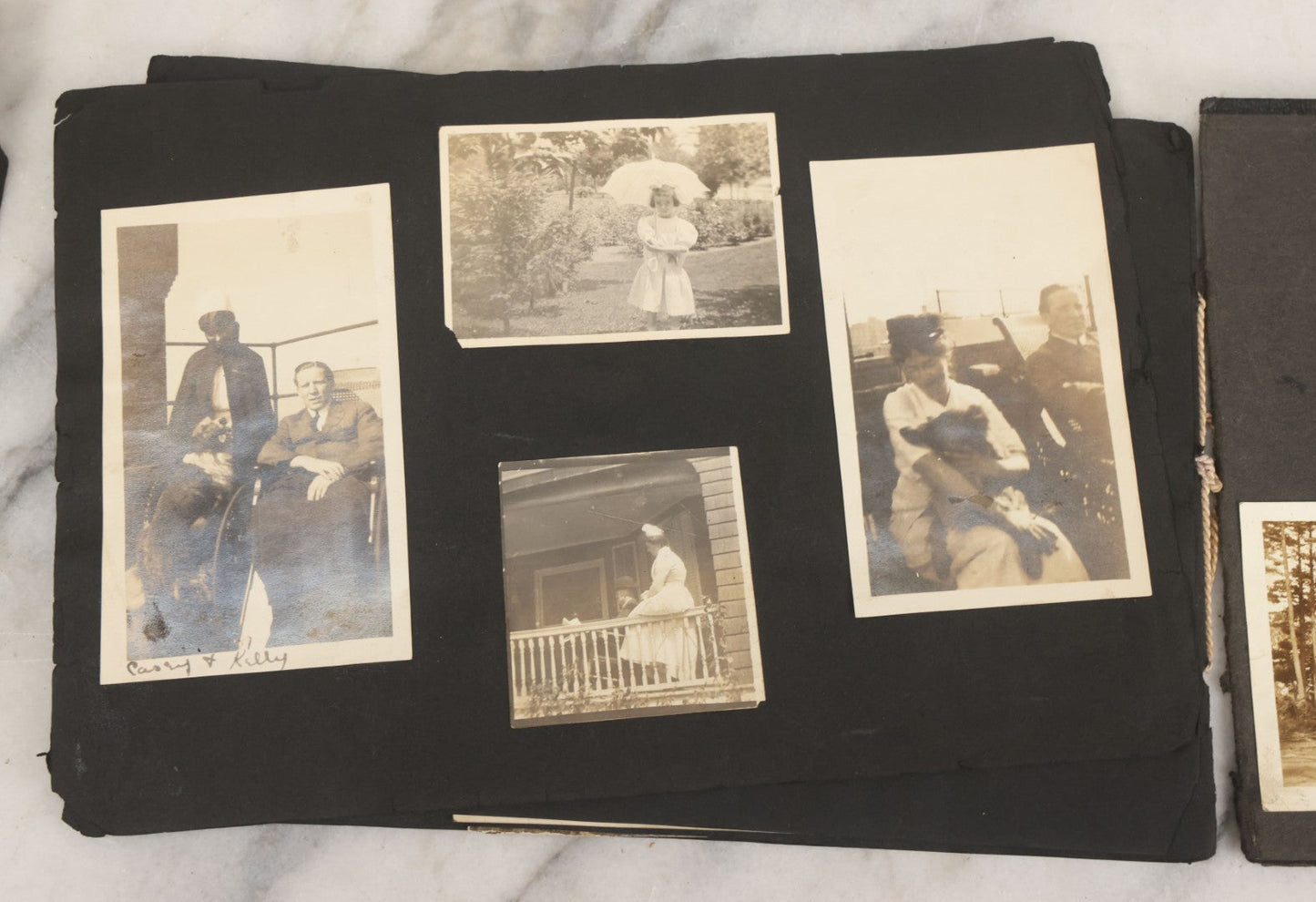 Lot 010 - Antique Vernacular Snapshot Photo Album With 90+ Photographs Circa 1910-1920, Including Baseball Player, Woman Posing With Flag, Bartenders, Many Dogs And Pets, And More