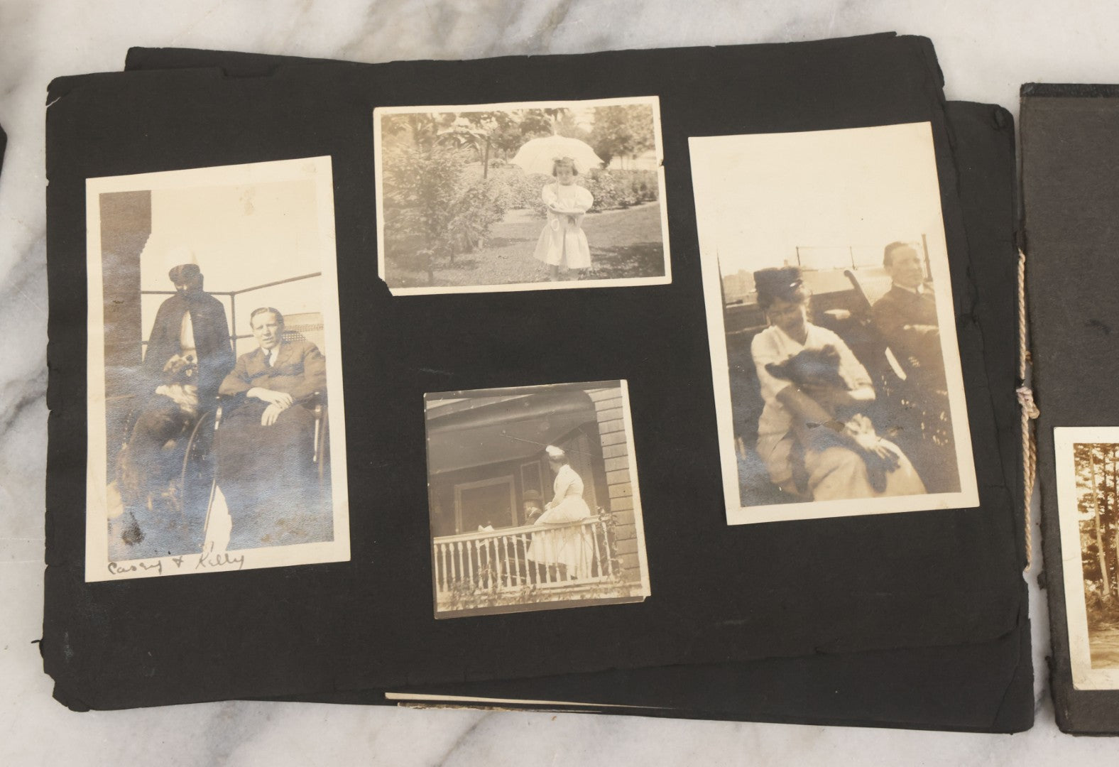 Lot 010 - Antique Vernacular Snapshot Photo Album With 90+ Photographs Circa 1910-1920, Including Baseball Player, Woman Posing With Flag, Bartenders, Many Dogs And Pets, And More