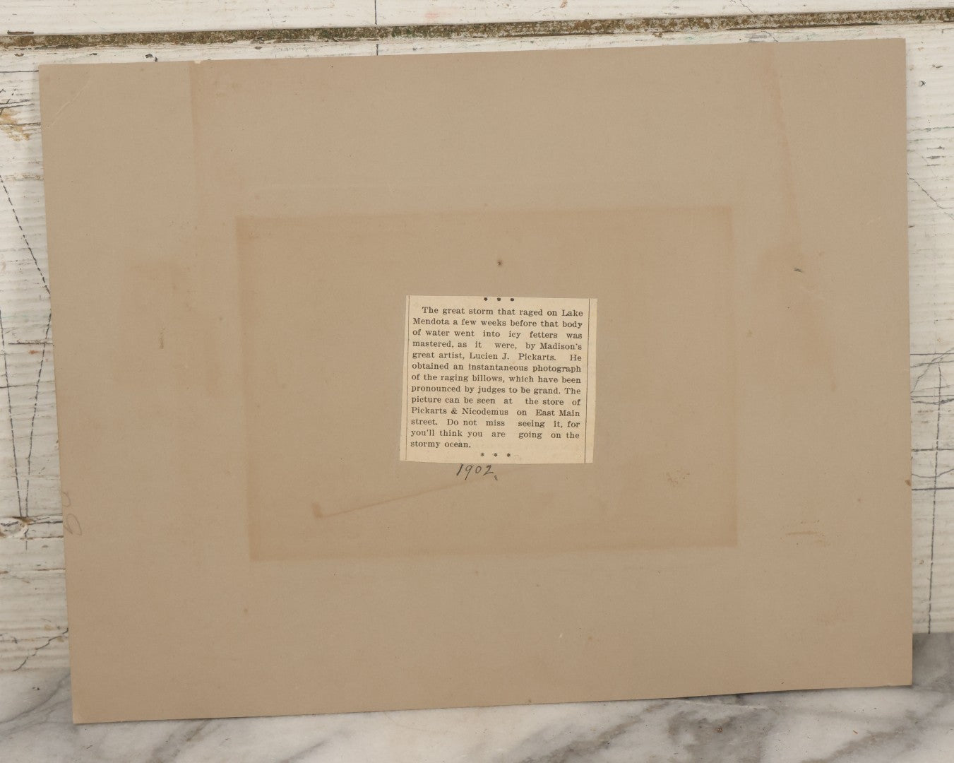 Lot 012 - Antique Boarded Photograph Of Lightning Storm Raging Over Lake Mendota, Madison, Wisconsin, Photographed And Signed By Lucien J. Pickarts, With Newspaper Write Up Promoting Photo On Verso, Note Small Loss To Photo Left Middle, 11" x 8-1/2"