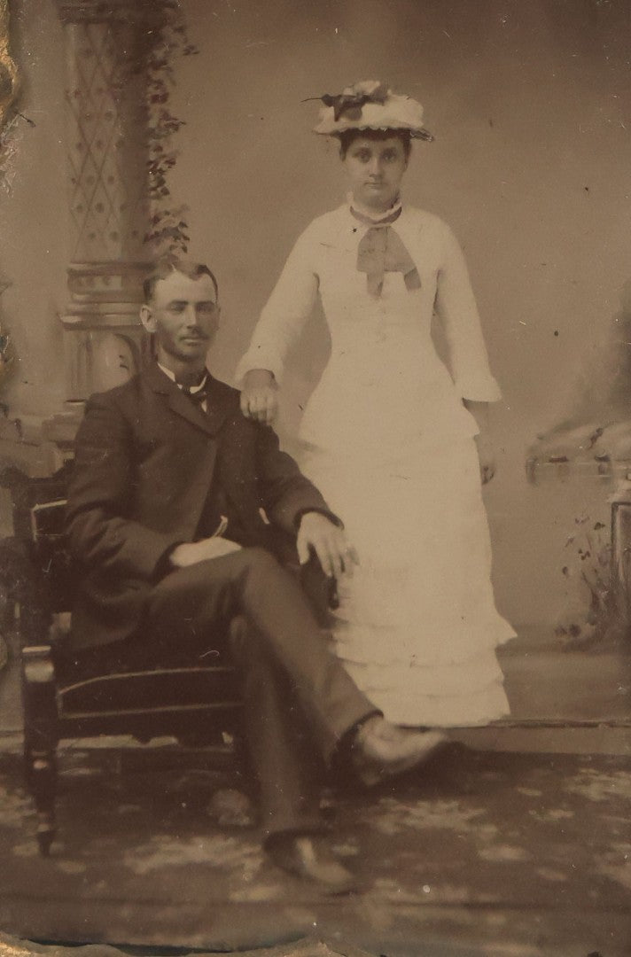 Lot 015 - Antique Tintype Photograph Of A Man And Woman Couple In Gold Painted Cast Iron Branch Frame With Flower Motif, Wire Hanger, 3-1/2" x 5-7/8"