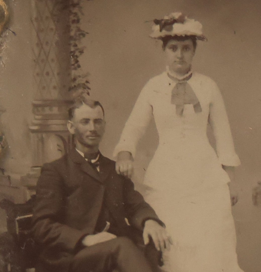 Lot 015 - Antique Tintype Photograph Of A Man And Woman Couple In Gold Painted Cast Iron Branch Frame With Flower Motif, Wire Hanger, 3-1/2" x 5-7/8"