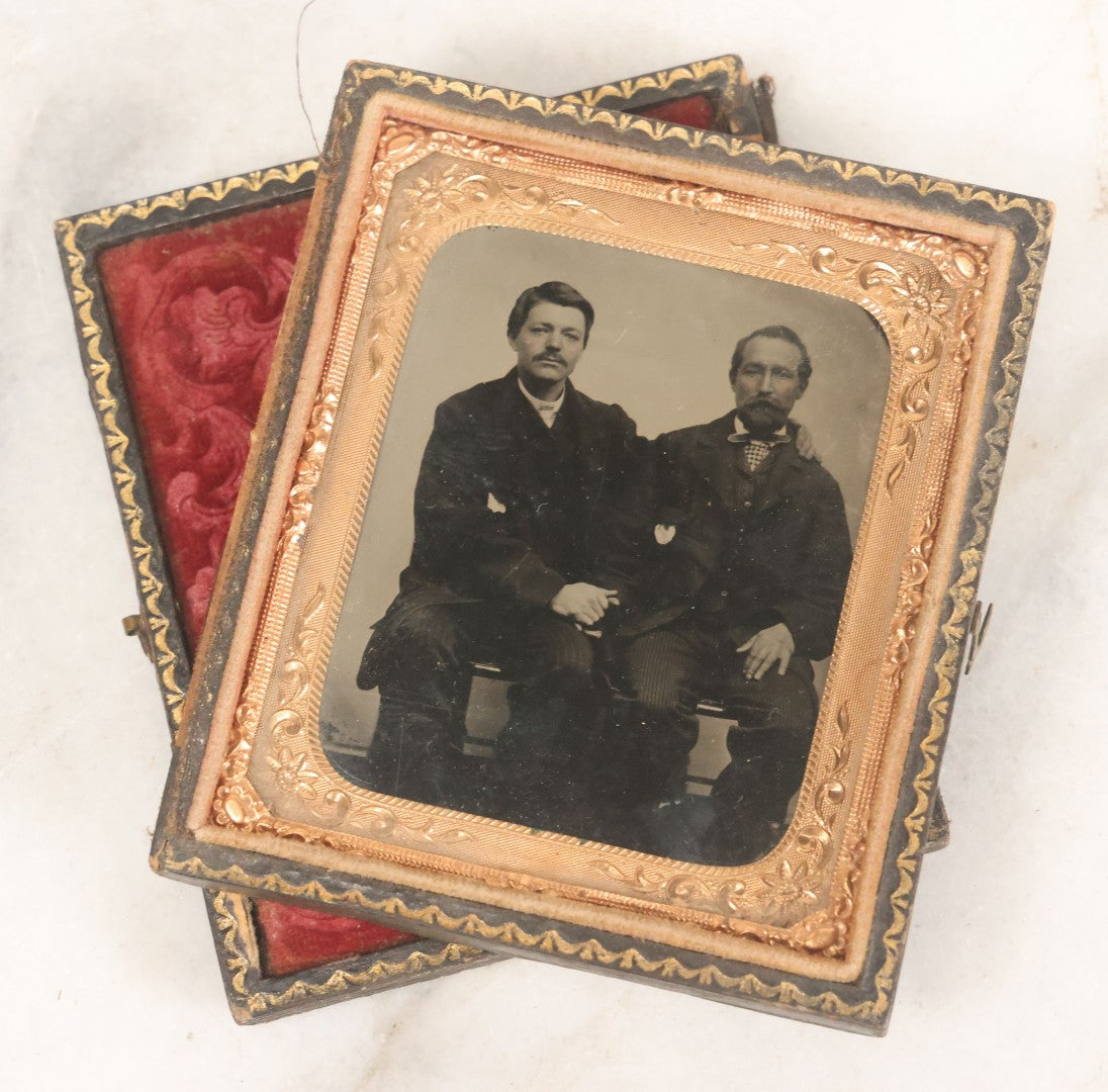 Lot 017 - Antique 1/6th Plate Tintype Photograph Of Two Men, Likely A Father And Son, Sharing An Embrace, Holding Hands, In Full Split Leatherette Union Case