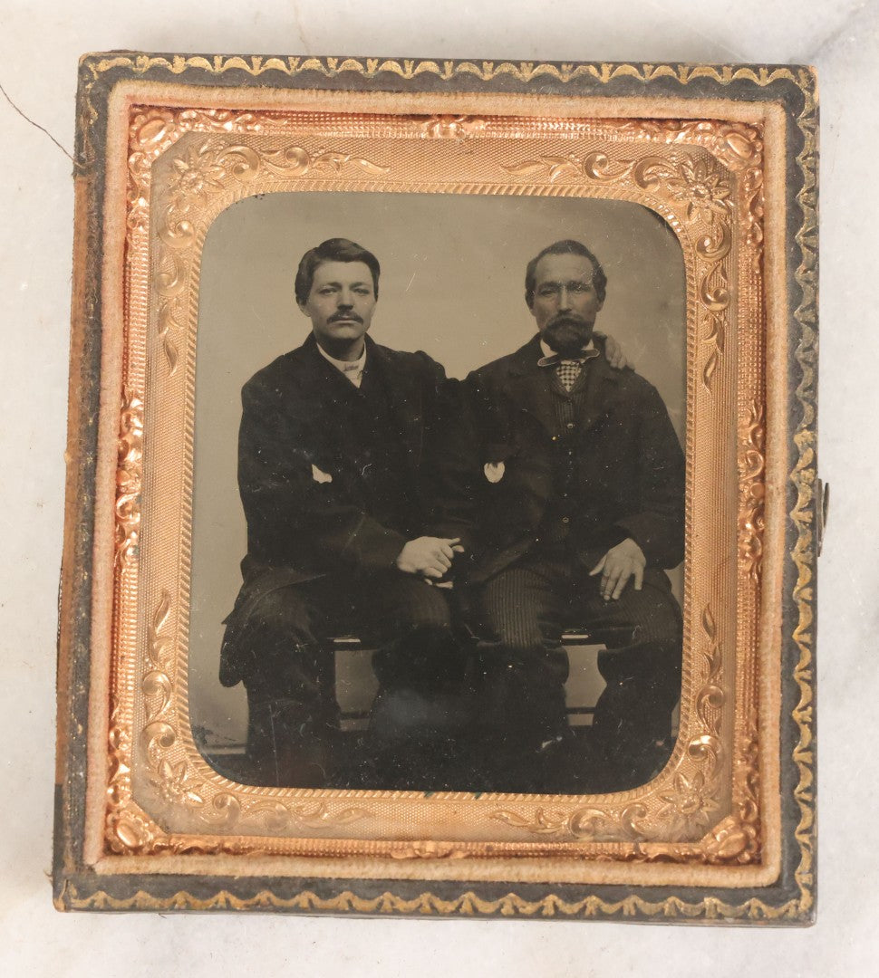 Lot 017 - Antique 1/6th Plate Tintype Photograph Of Two Men, Likely A Father And Son, Sharing An Embrace, Holding Hands, In Full Split Leatherette Union Case
