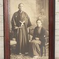 Lot 018 - Antique Trimmed Boarded Photograph Of A Japanese Couple In Frame, Identified On Verso As Shikazo Or Rokuzo, Age 73 Years, Photographed January 6, 1914, Tsujiko Town (Town Or Neighborhood), 4-3/8" x 6-3/8"