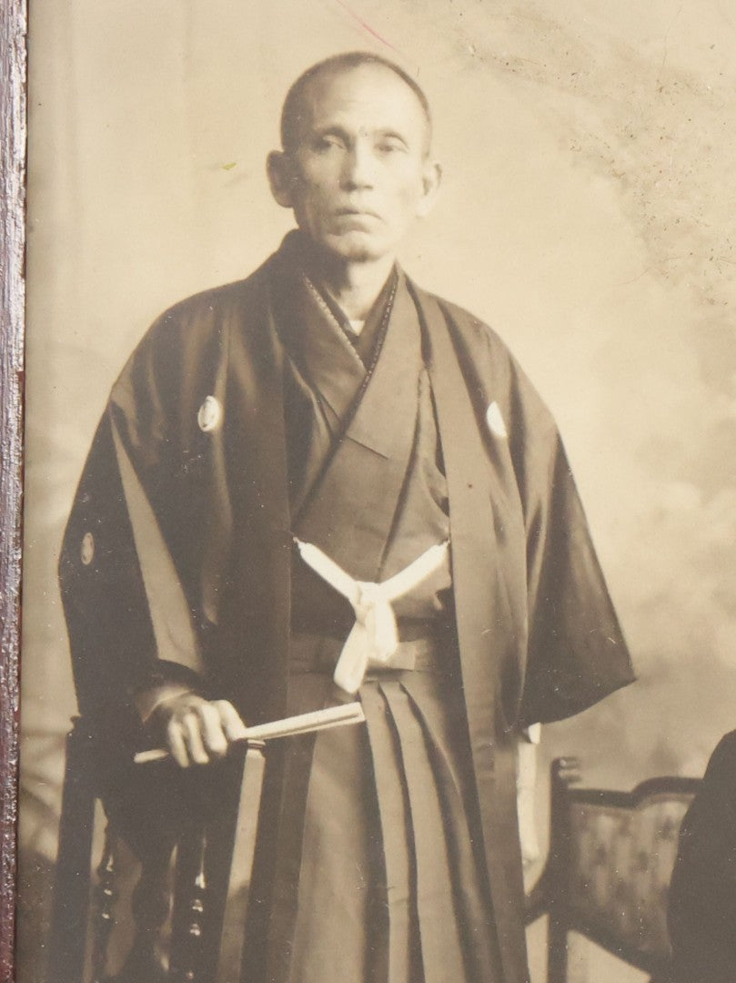 Lot 018 - Antique Trimmed Boarded Photograph Of A Japanese Couple In Frame, Identified On Verso As Shikazo Or Rokuzo, Age 73 Years, Photographed January 6, 1914, Tsujiko Town (Town Or Neighborhood), 4-3/8" x 6-3/8"