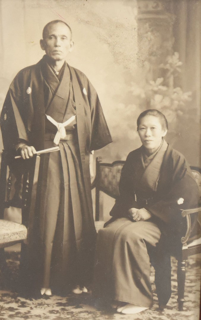 Lot 018 - Antique Trimmed Boarded Photograph Of A Japanese Couple In Frame, Identified On Verso As Shikazo Or Rokuzo, Age 73 Years, Photographed January 6, 1914, Tsujiko Town (Town Or Neighborhood), 4-3/8" x 6-3/8"
