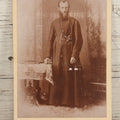 Lot 019 - Antique Cabinet Card Photograph Of A Bearded Priest In Black Robe With Large Pectoral Crucifix Tucked In Belt, Frank Lariviere, Photographer, Central Falls & Pawtucket, Rhode Island