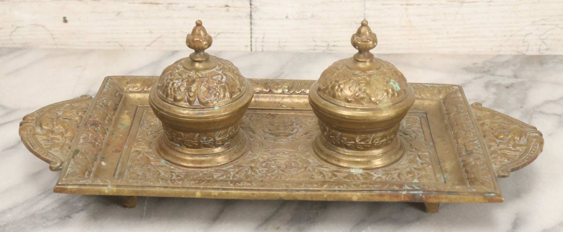 Lot 027 - Antique Cast Brass Double Inkwell And Desk Tray With Cherub And Green Man Motifs, Hinged Lids, Underside Marked 3143, No Inserts