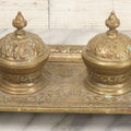 Lot 027 - Antique Cast Brass Double Inkwell And Desk Tray With Cherub And Green Man Motifs, Hinged Lids, Underside Marked 3143, No Inserts