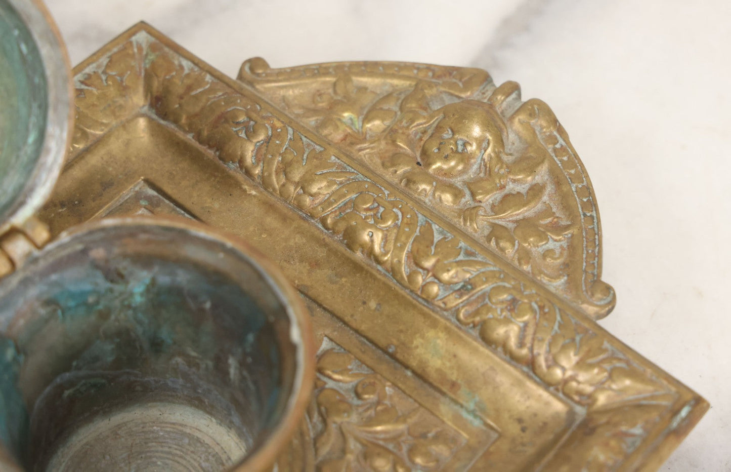 Lot 027 - Antique Cast Brass Double Inkwell And Desk Tray With Cherub And Green Man Motifs, Hinged Lids, Underside Marked 3143, No Inserts