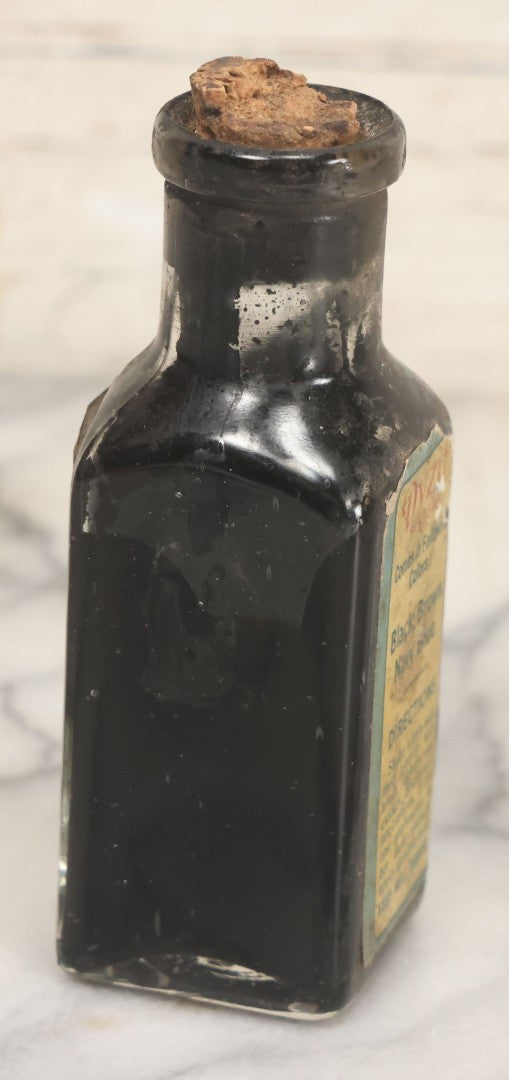 Lot 040 - Grouping Of Four Vintage Ink And Polish Glass Bottles With Paper Labels Including Dyzit Straw Hat Renewer, Sanford's Premium Writing Fluid, Bixby Mahogany Shoe Cleaner, And Bixby Royal Shoe Polish